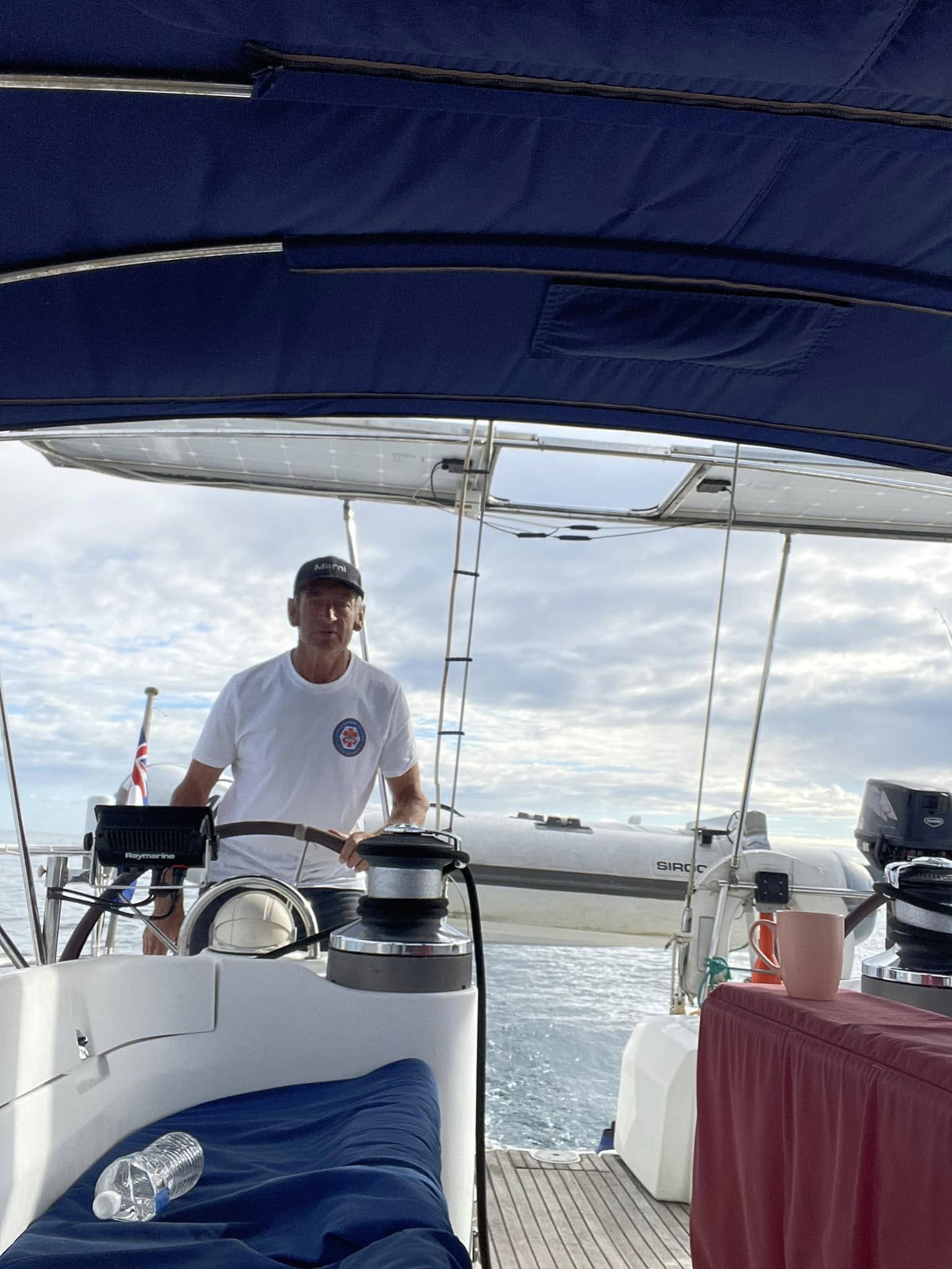 Matt Dawe at the wheel of a sailing yacht